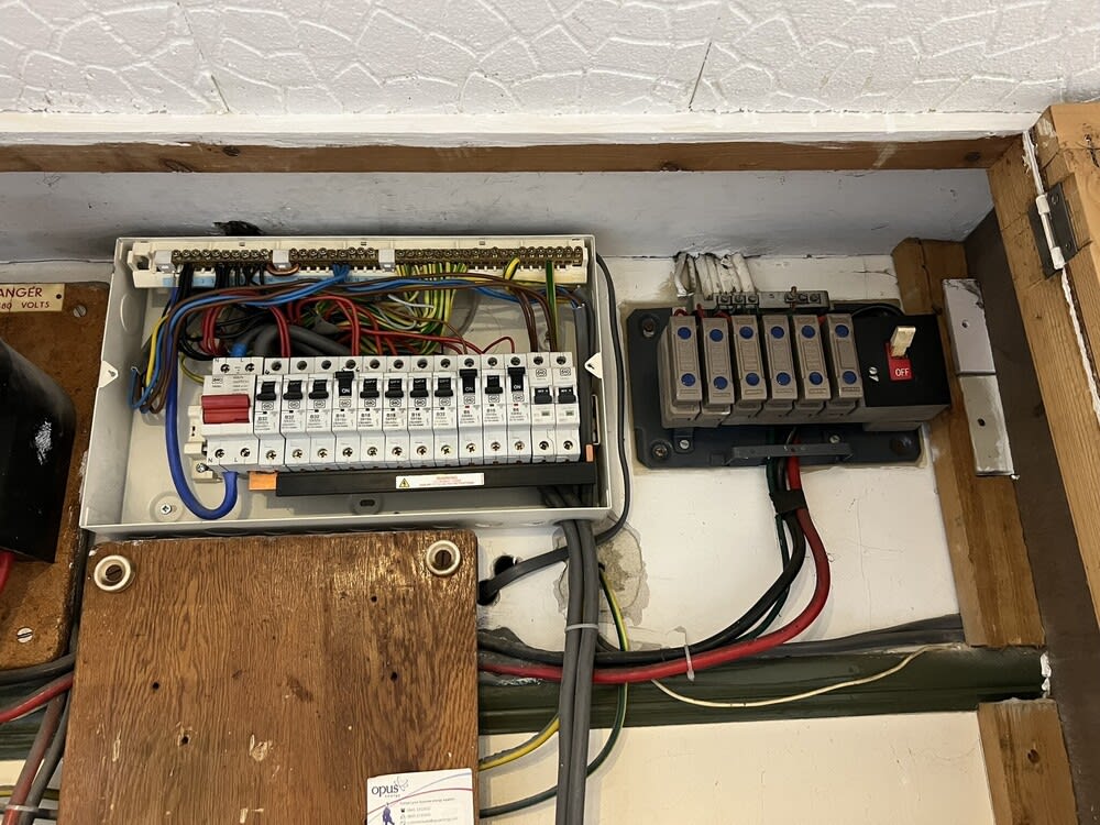 Professional electrician performing EICR in a residential property