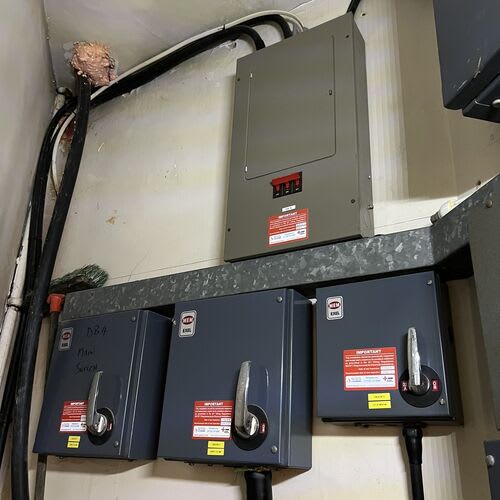 Chase Farm Electrical Contractors conducting an Electrical test and inspection on an old 3 phase fuse board in a nursing home for safety and compliance