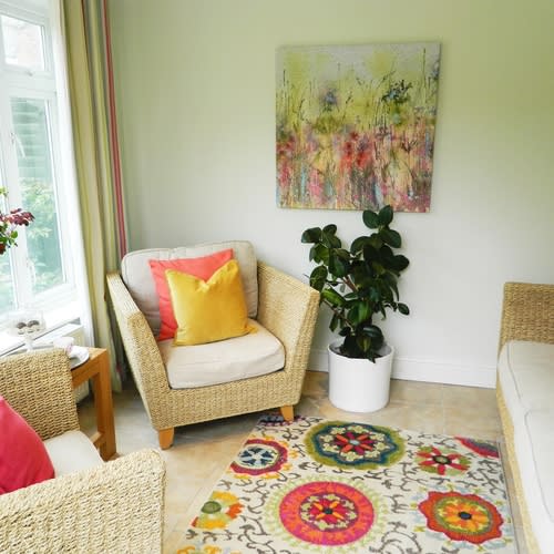 Conservatory in Chislehurst  styled with bright colours  coral pinks and yellows to attract buyers to sell 