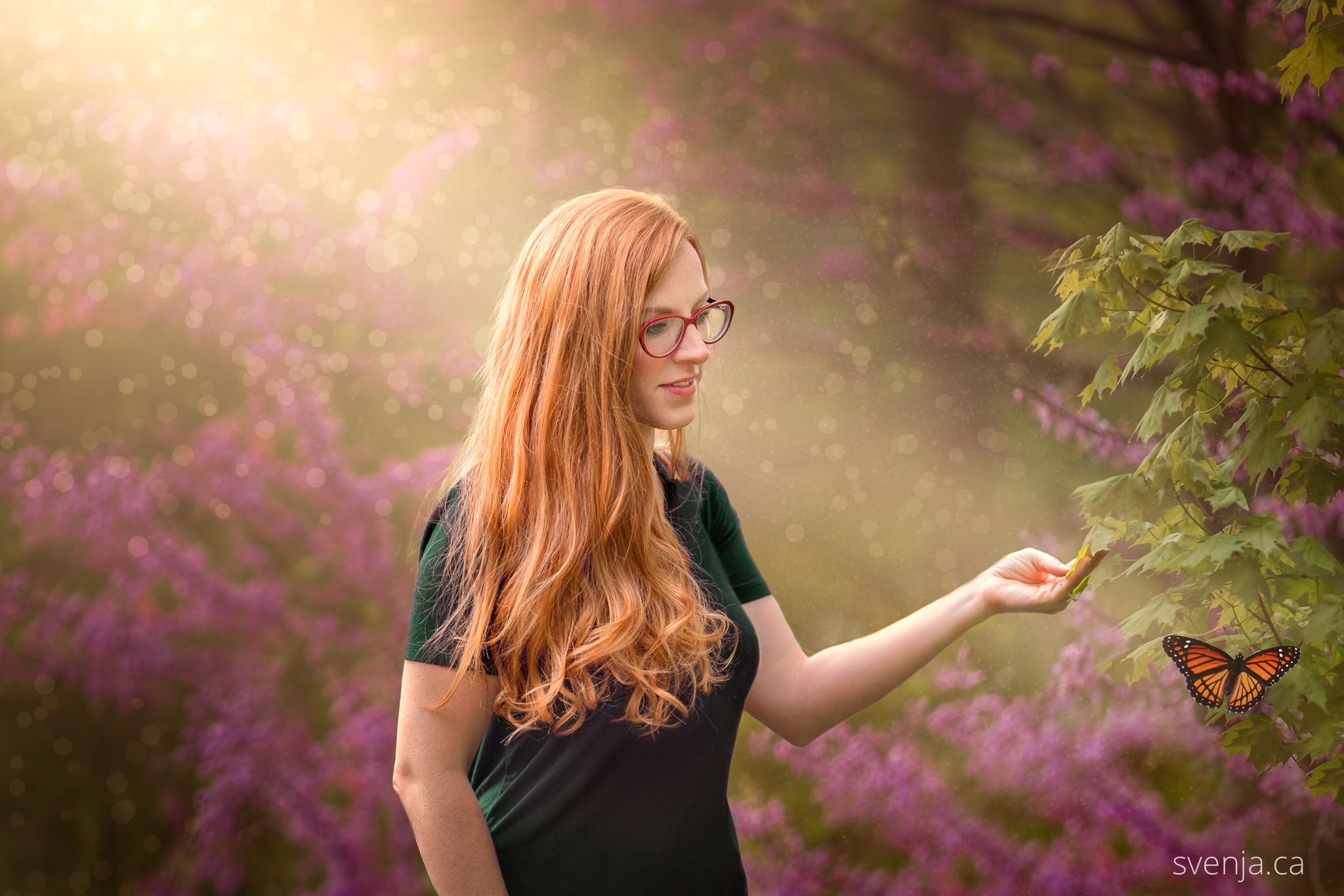 red haired woman looking at a butterfly