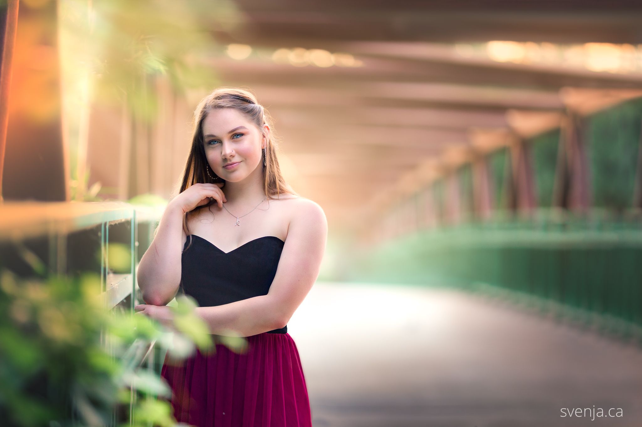 teenage girl in prom dress on a bridge