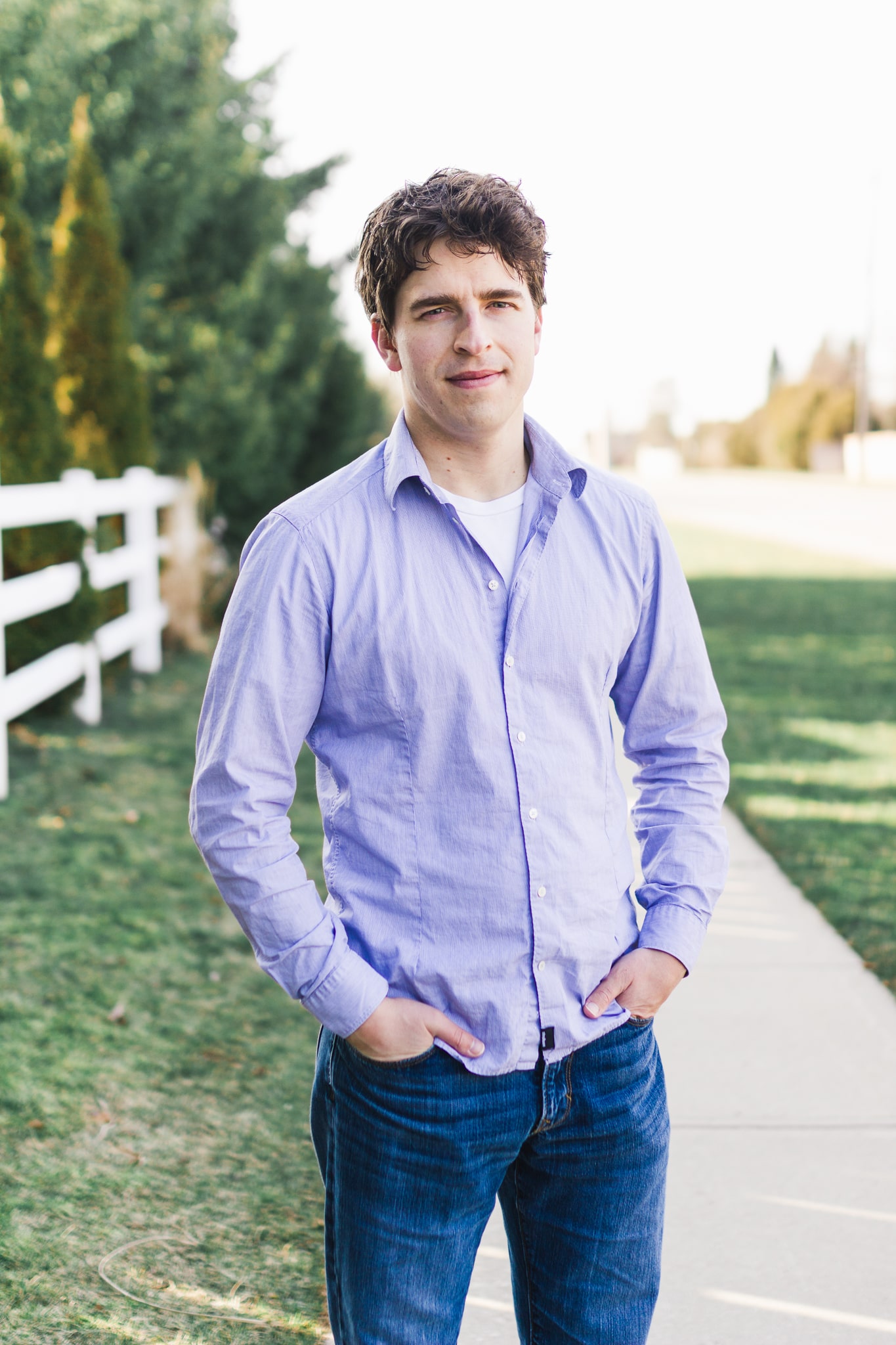 picture of a man, hands in pockets, on a sidewalk