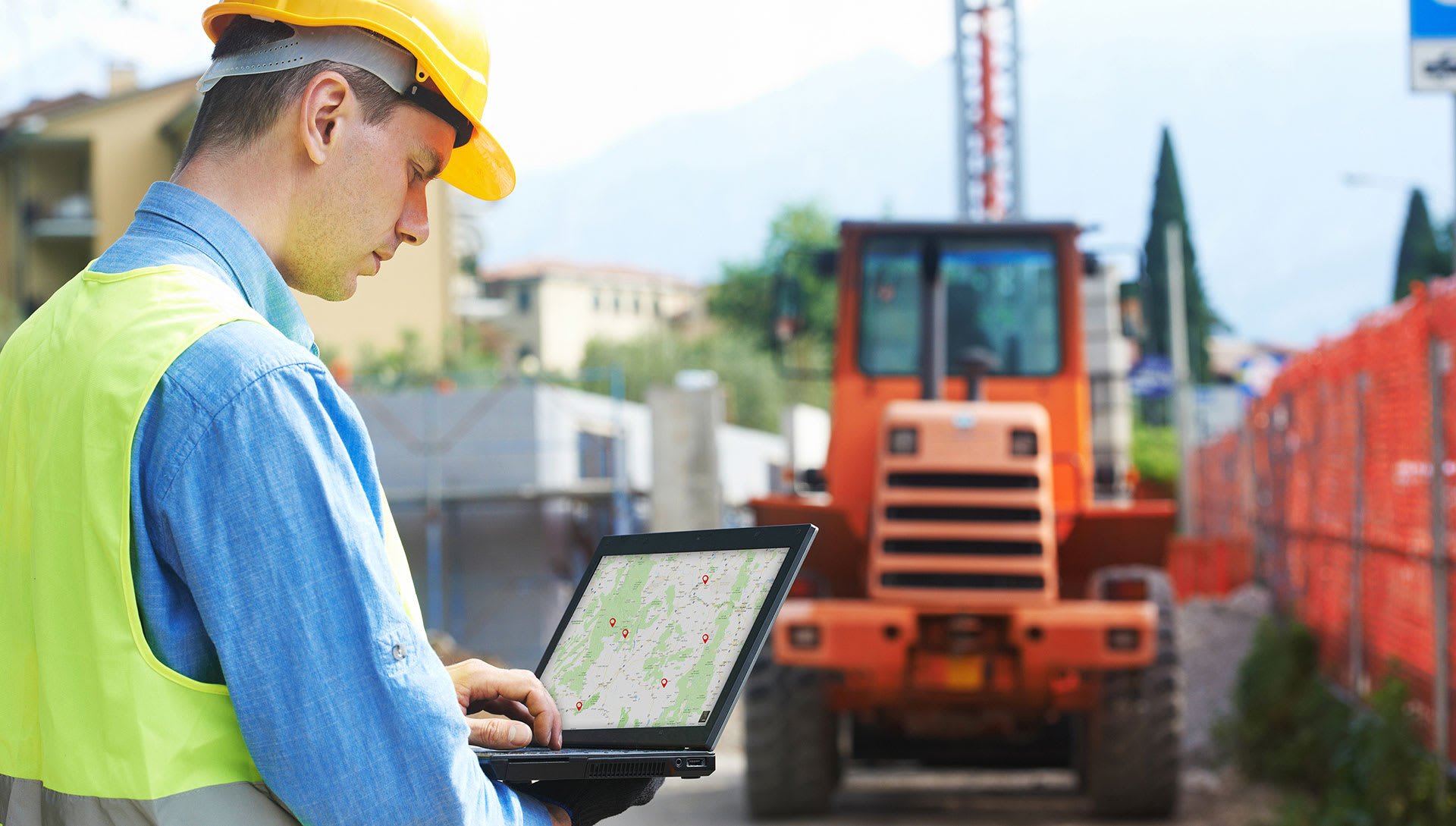 Worker at jobsite using ESCO Track GPS map to locate assets and equipment