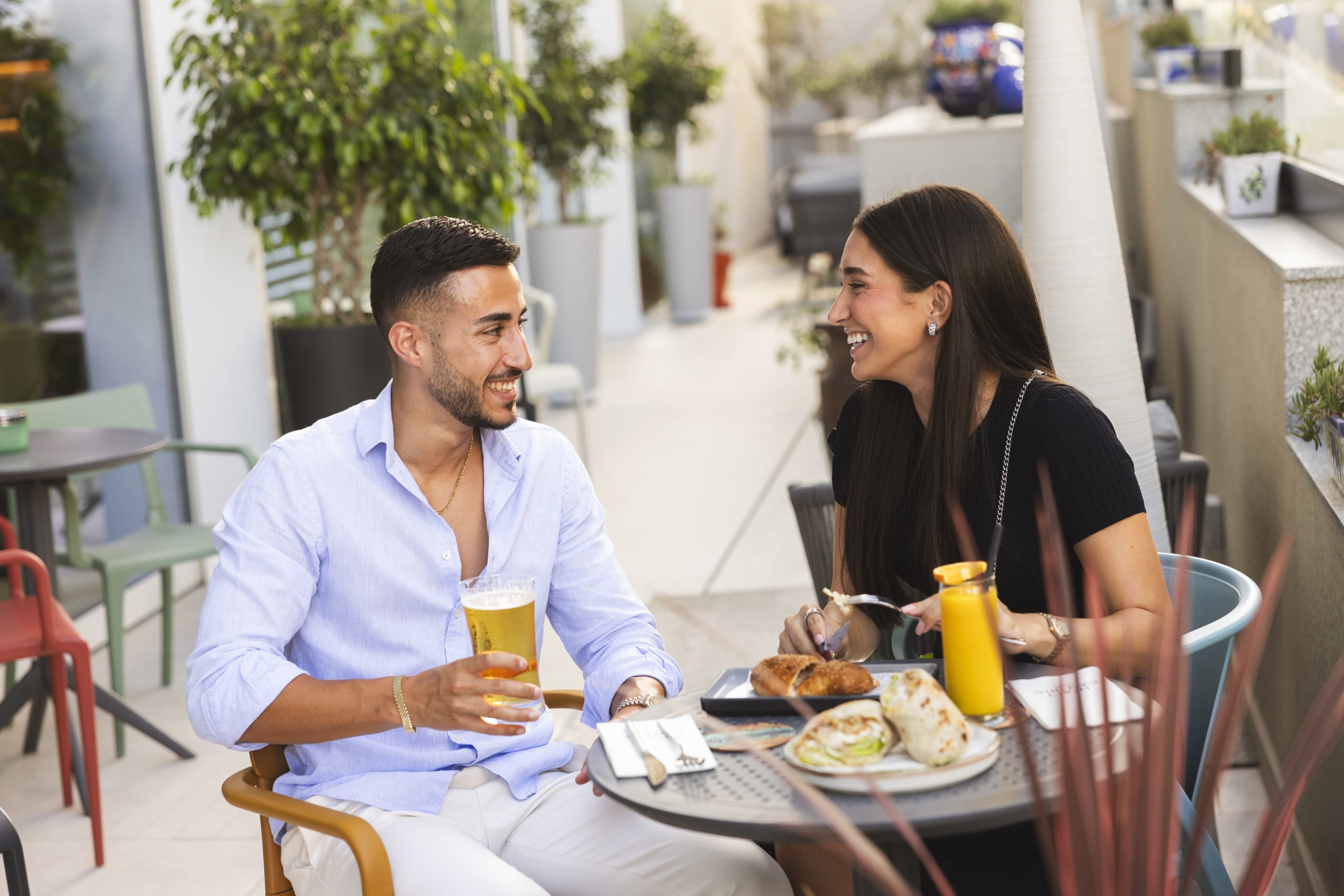 Couple Smiling Whilst Having a Beer