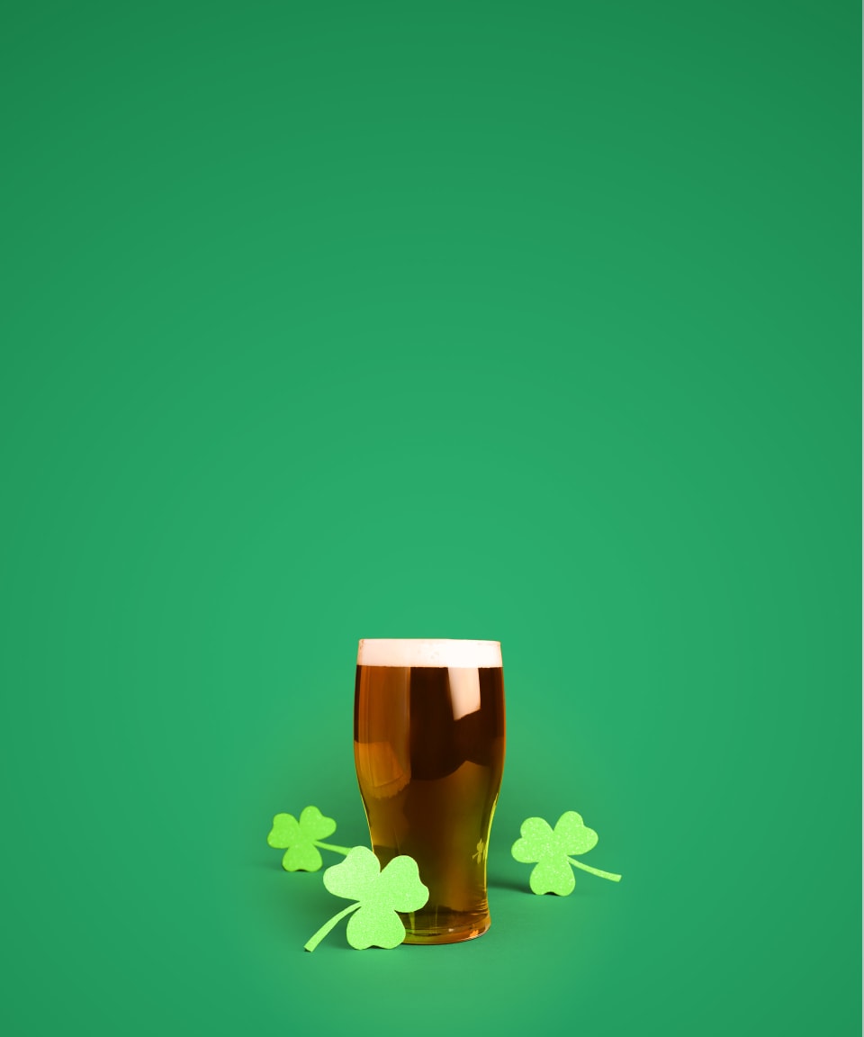 Paper shamrocks around a pint of beer for Confetti's Virtual Irish Beer Tasting