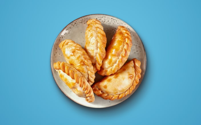 5 empanadas on a plate for Confetti's Virtual BYO Empanada Cooking Class