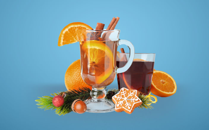 Glass of mulled wine and cider with festive holiday decorations (preview)