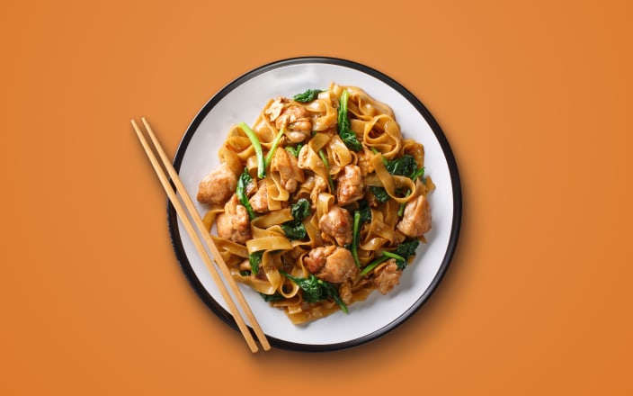 Thai Pad See Ew noodles with chicken and vegetables on a plate with chopsticks (preview)