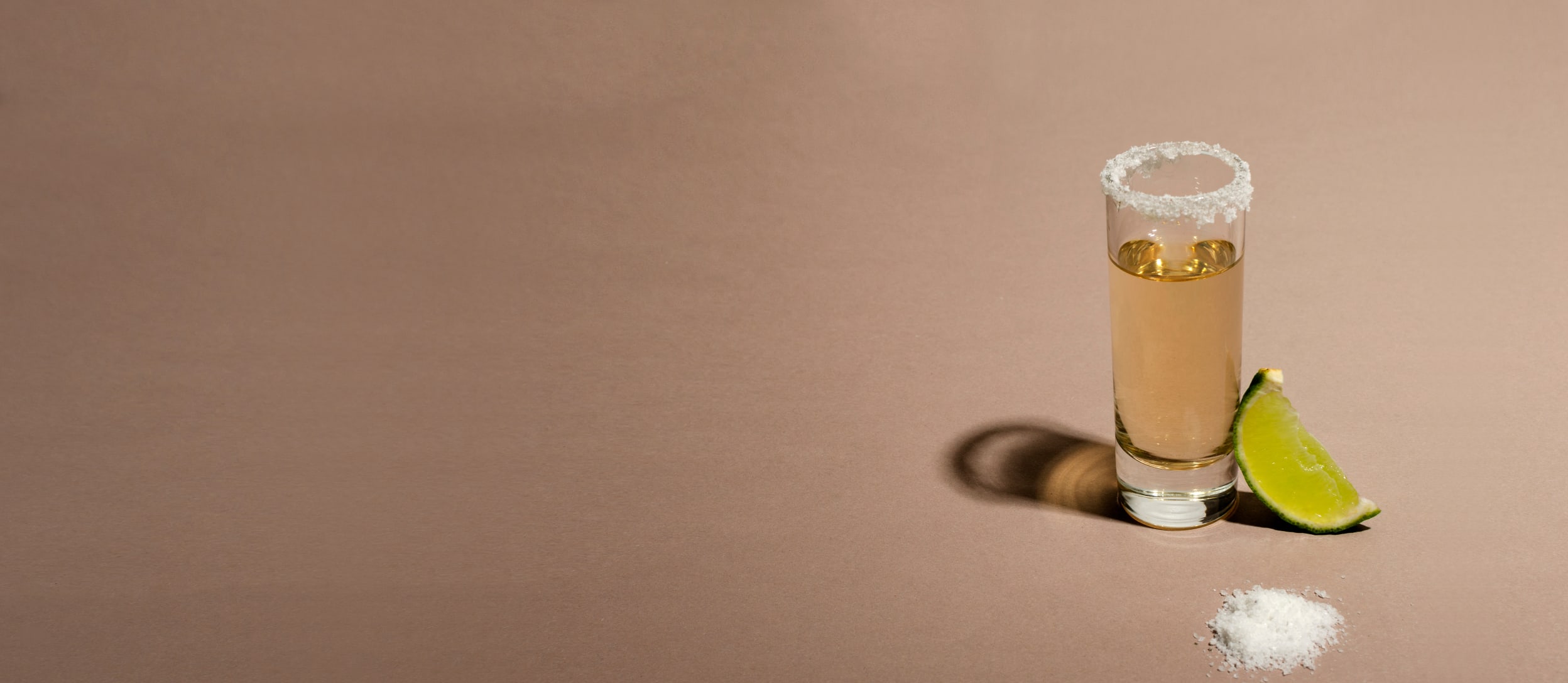 Tequila shot glass with salt on the rim and a slice of lime (large)