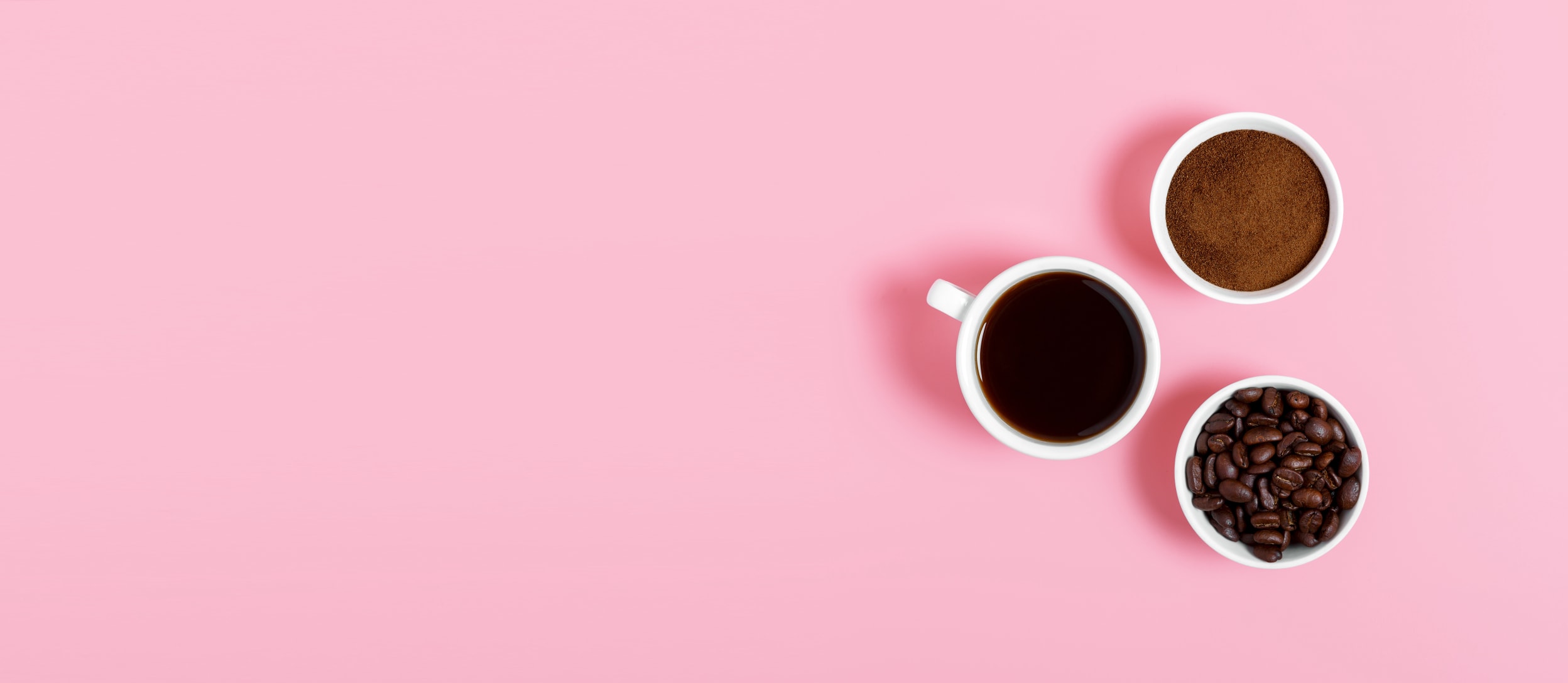 A birds eye view of two cups of coffee and a bowl of coffee beans for Confetti's Virtual Coffee Tasting Class