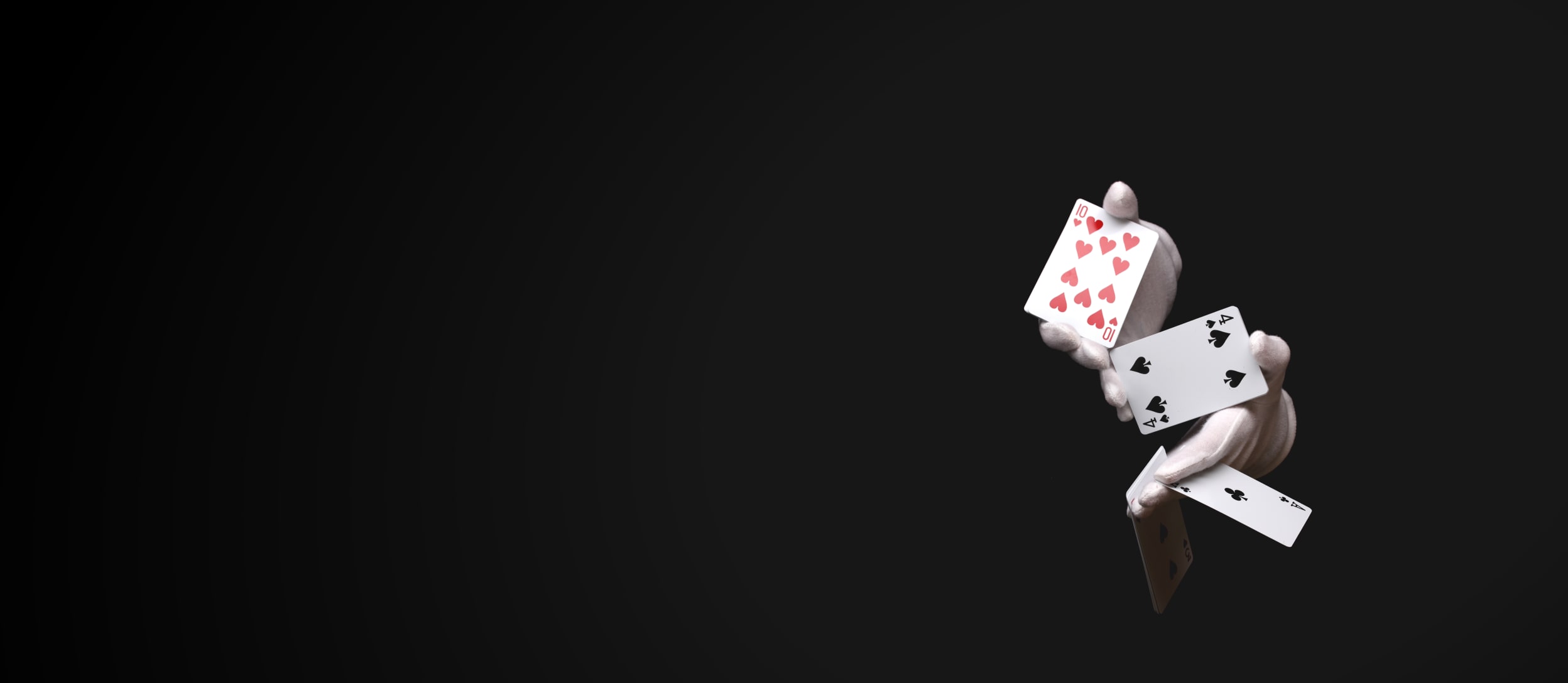 Gloved magician hands showing various cards for Confetti's Virtual Magic Show