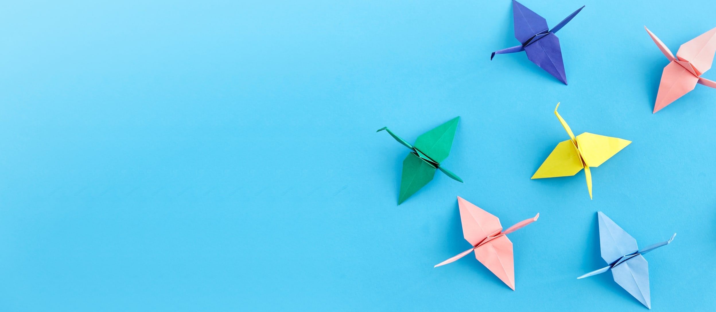 Paper cranes in various colors for Confetti's Virtual Origami Class with Kits