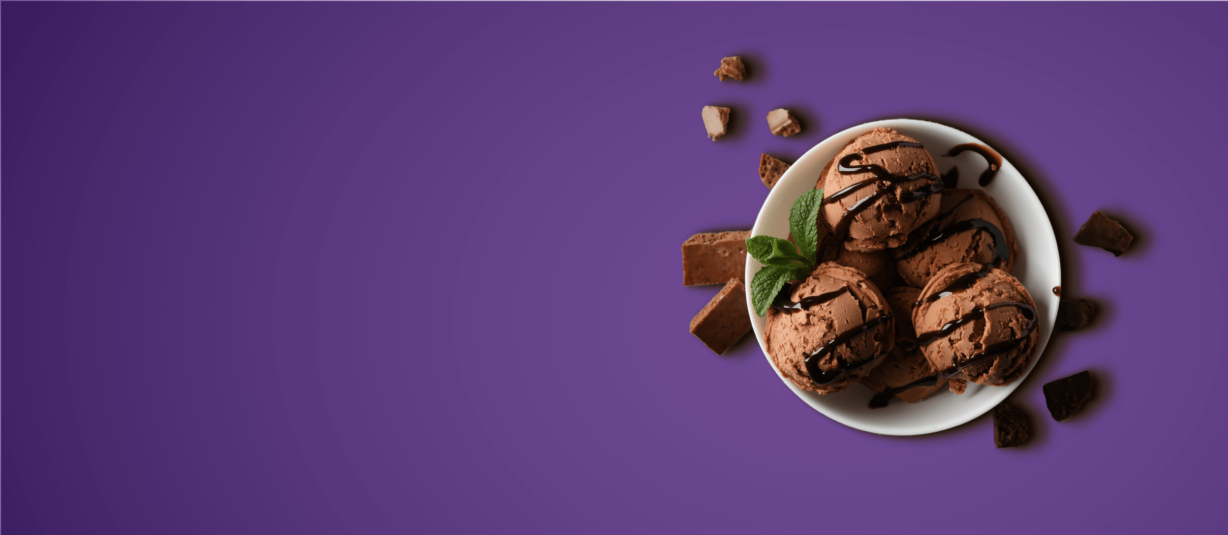 Chocolate ice cream in a bowl with chocolate sauce drizzled on top for Confetti's Virtual Ice Cream Making Class