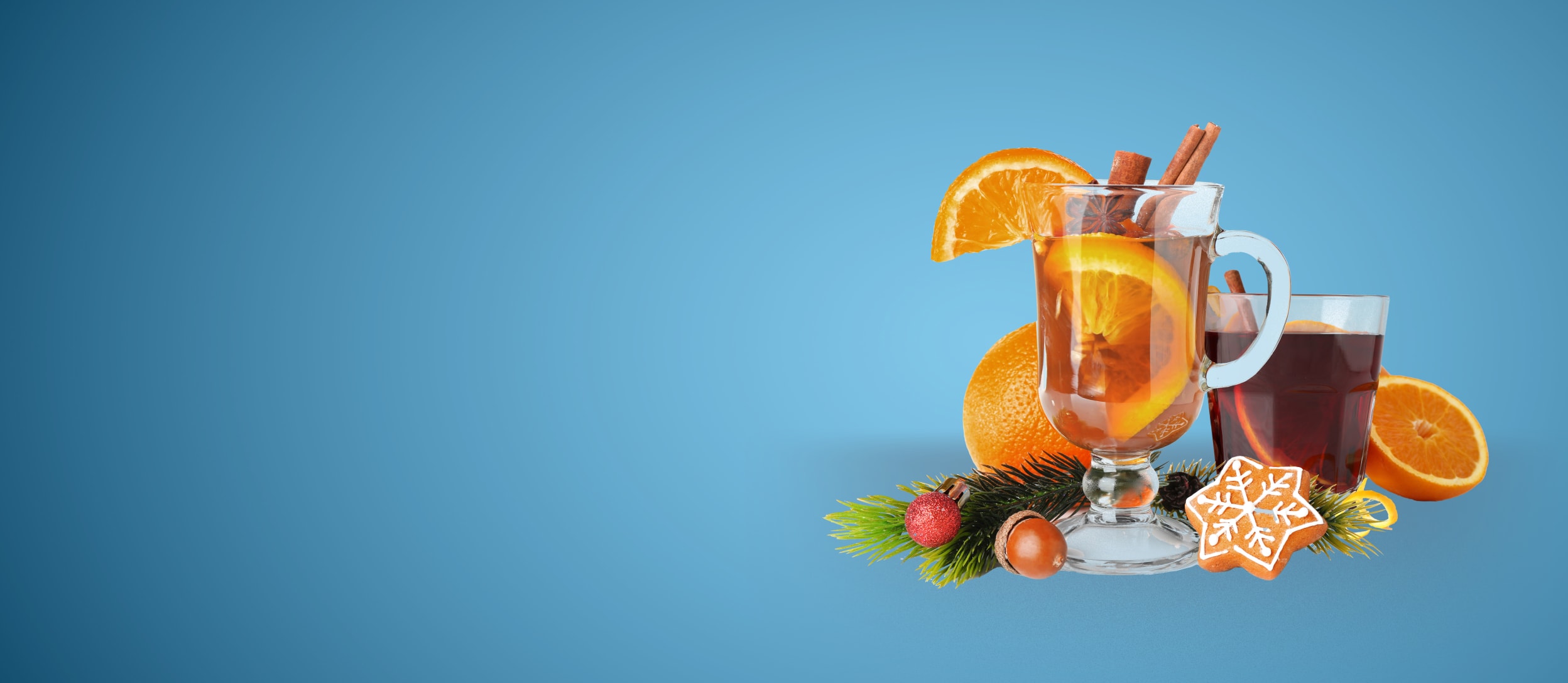 Glass of mulled wine and cider with festive holiday decorations (large)