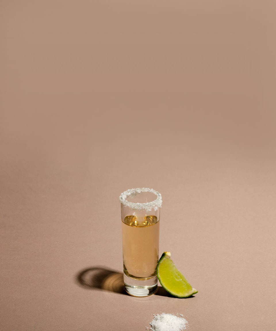 Tequila shot glass with salt on the rim and a slice of lime (small)