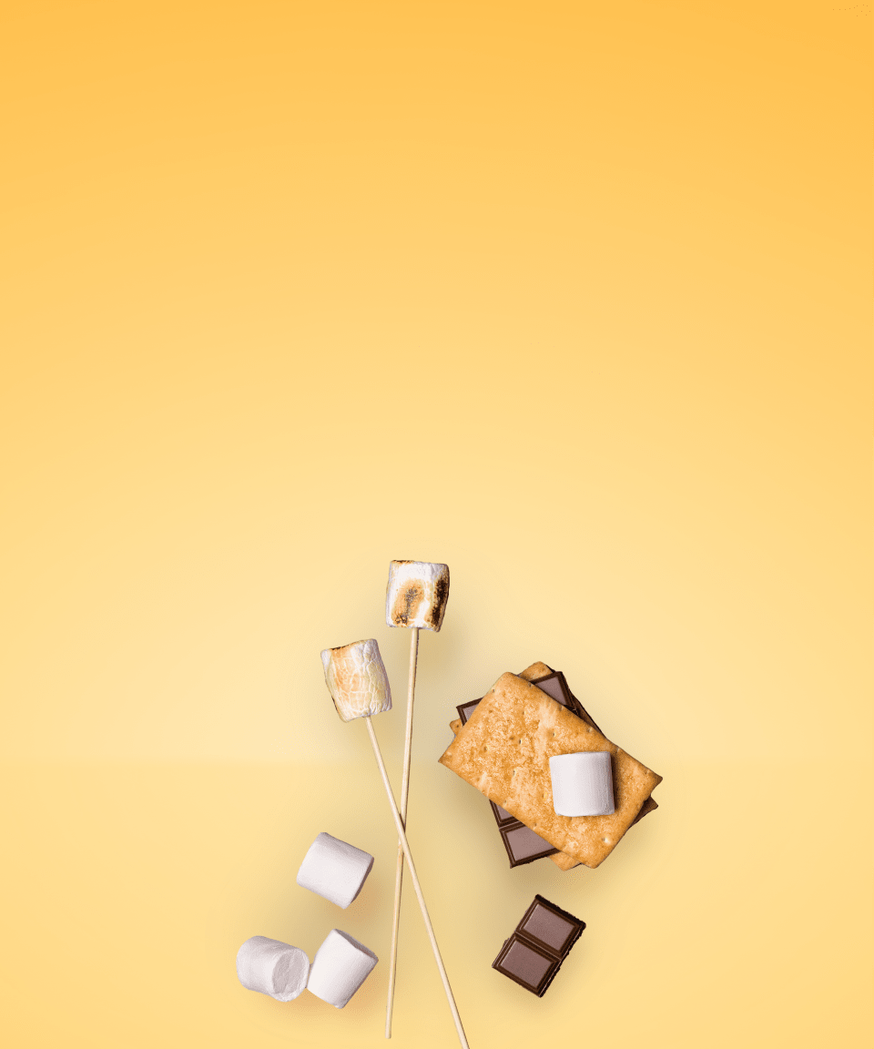 Marshmallows, chocolate bars, and toasted marshmallows on a stick next to a fully made s'more for Confetti's Virtual S'mores Box