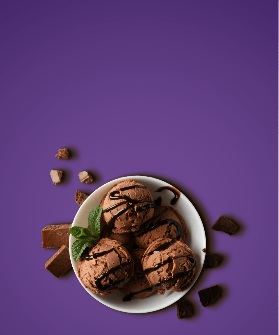 Chocolate ice cream in a bowl with chocolate sauce drizzled on top for Confetti's Virtual BYO Ice Cream Making Class