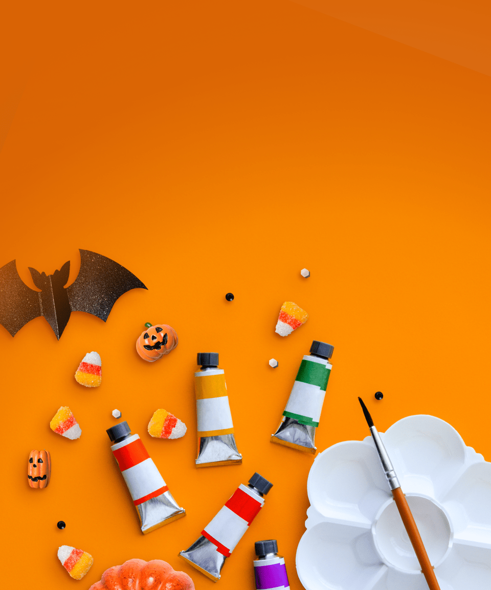 Candy corn, mini pumpkins, paints, and an empty paint tray for Confetti's Virtual Halloween Painting Class