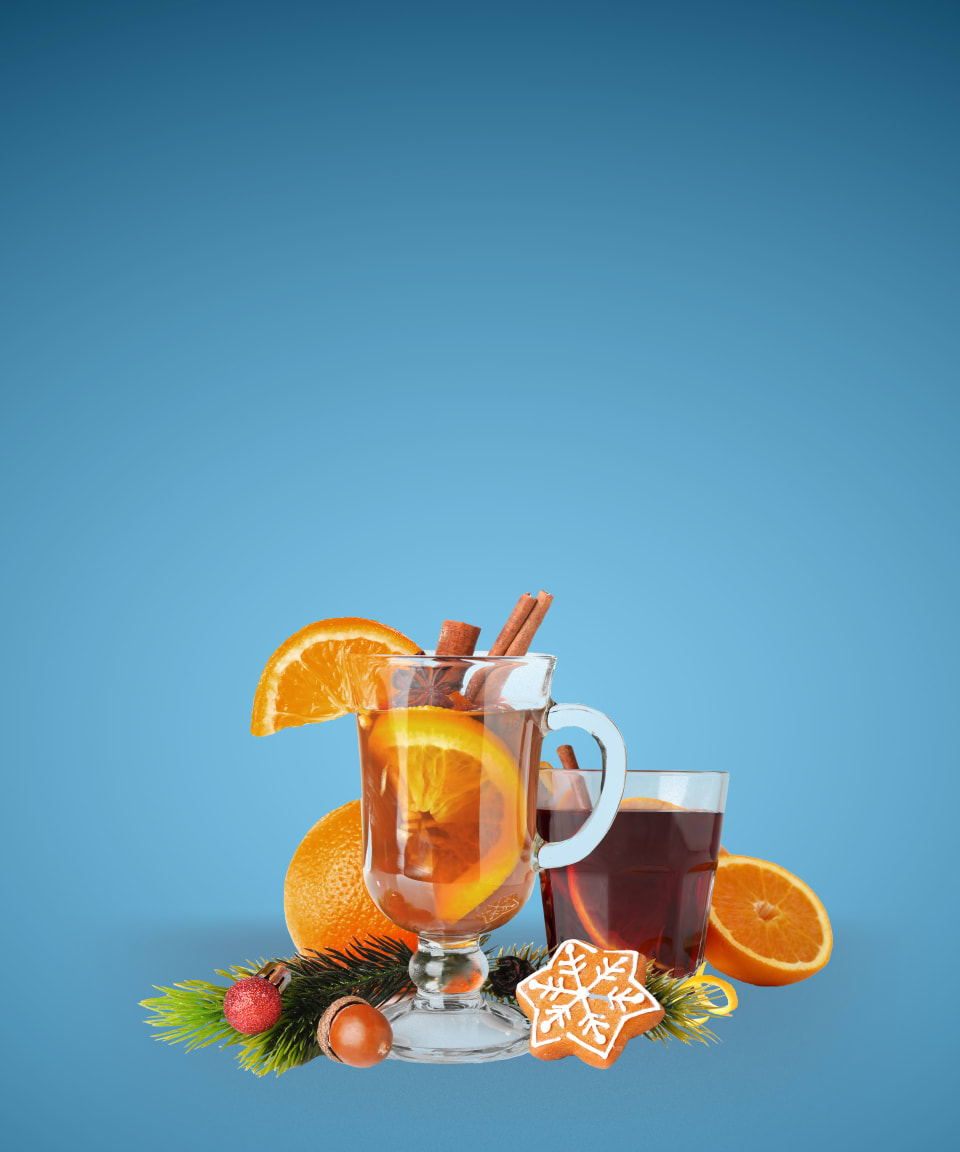 Glass of mulled wine and cider with festive holiday decorations (small)