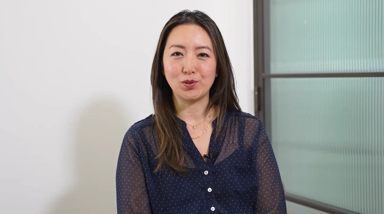 woman sat in a blue shirt