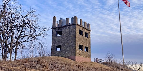 Oddsconsin 24 - Elk Mound Tower A rustic stone tower sits atop a hill on