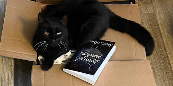 Sammy, a Benevolent Tyrant Sammy enjoyed my box of new books almost as much
