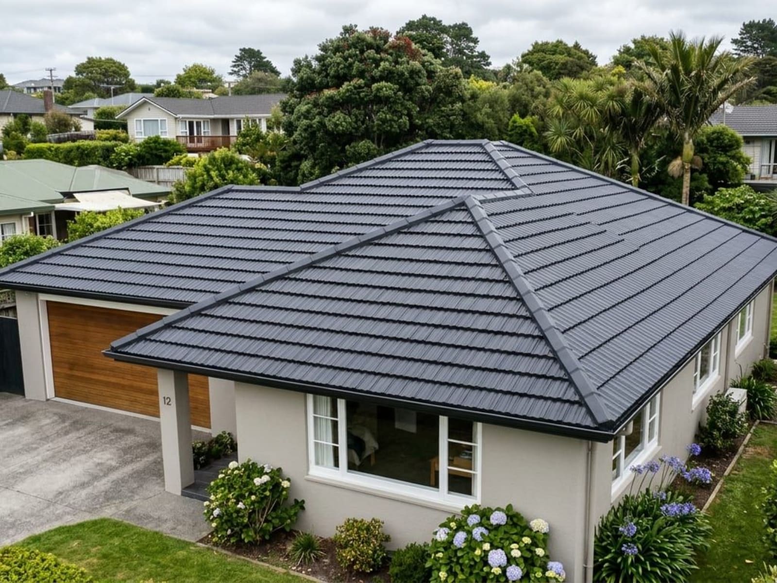 Freshly coated concrete tile roof with clean ridge lines