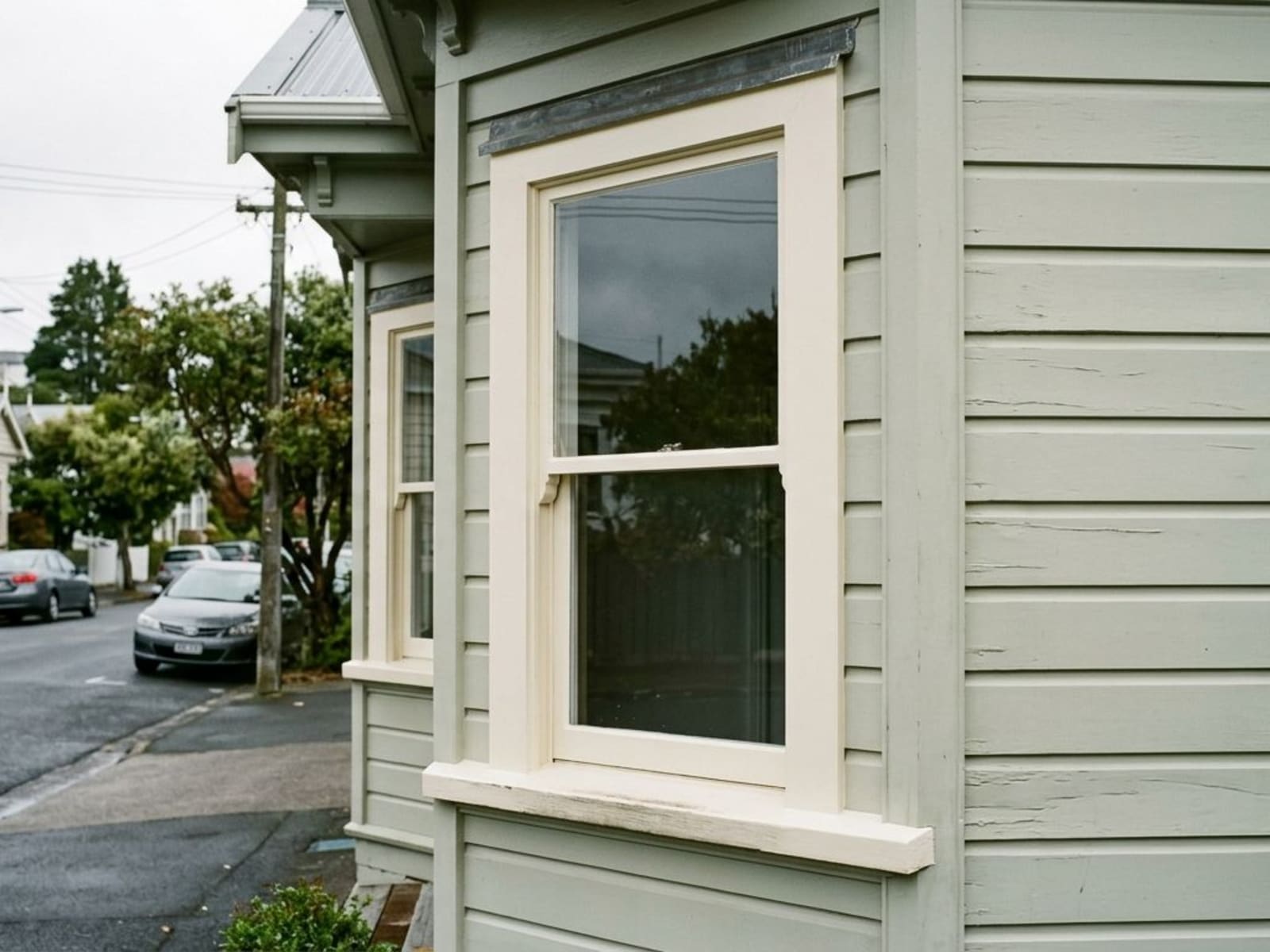 Freshly painted window sill and facings on a weatherboard villa