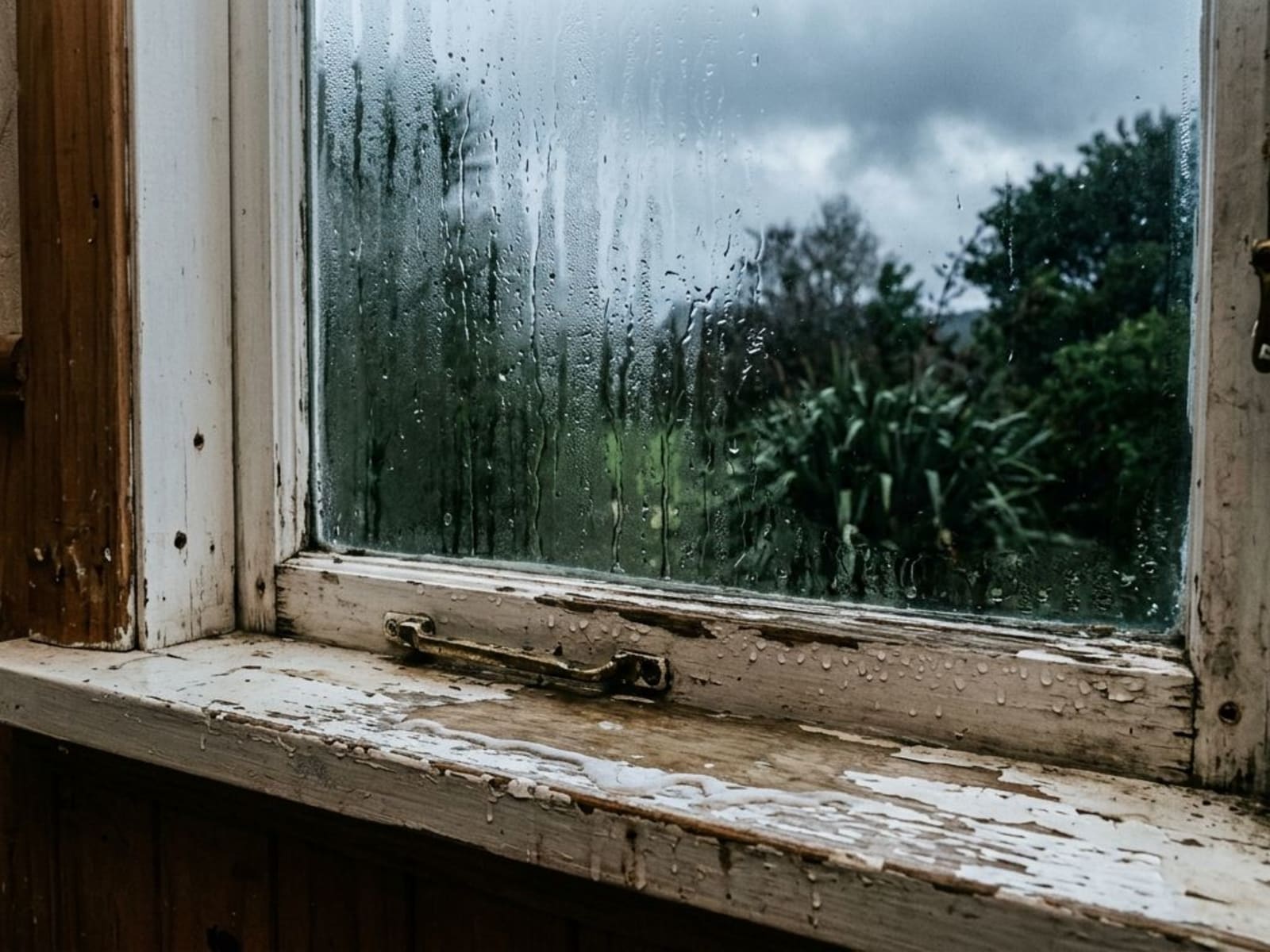 Condensation running down the inside of a single-glazed window