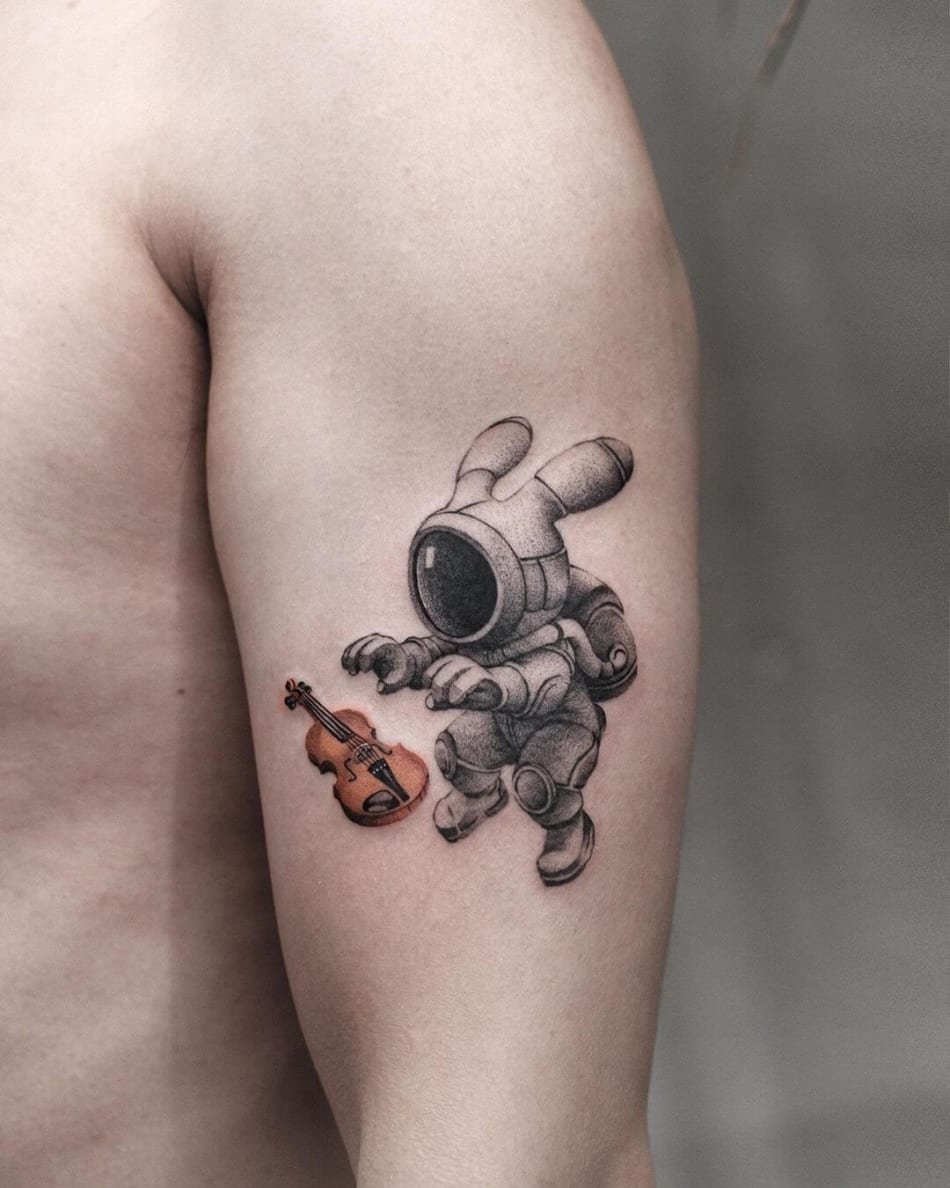 Tattoo of a bunny astronaut with a violin by Akiwong