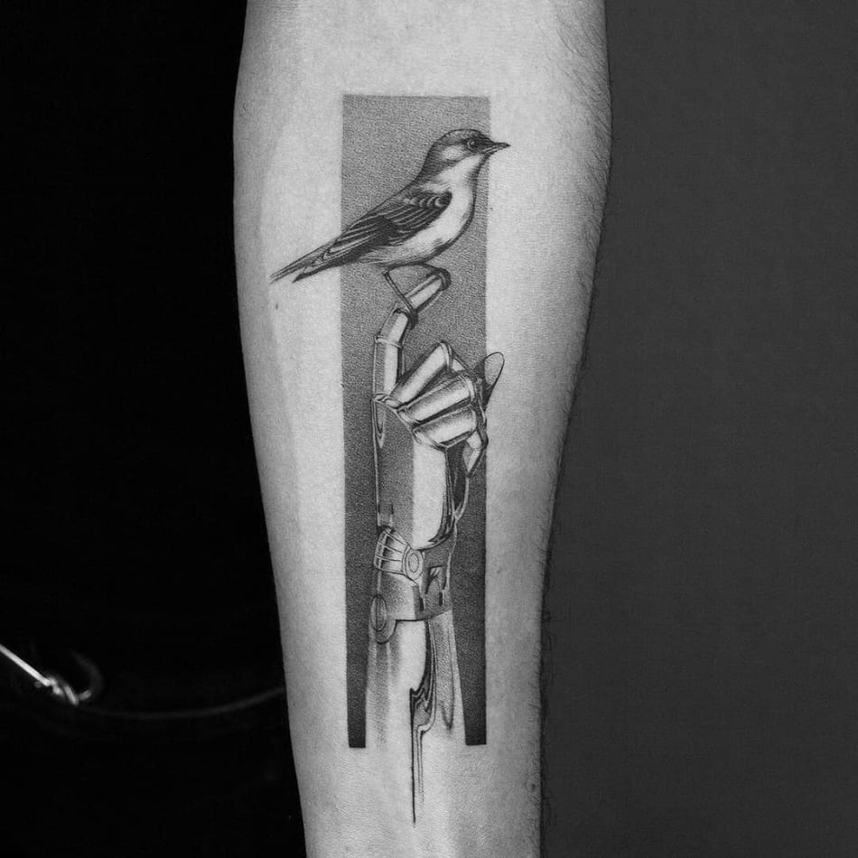 Bird sitting on robot hand tattoo by Amanda Piejak