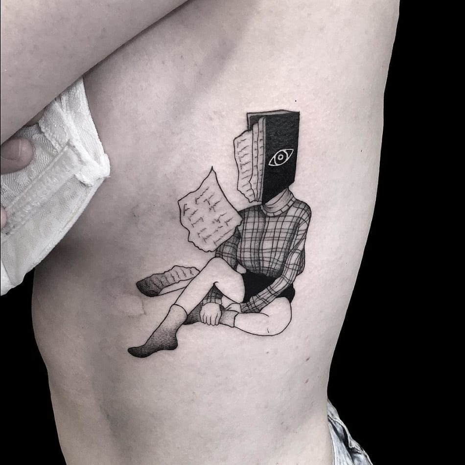 Book pages reading Tattoo