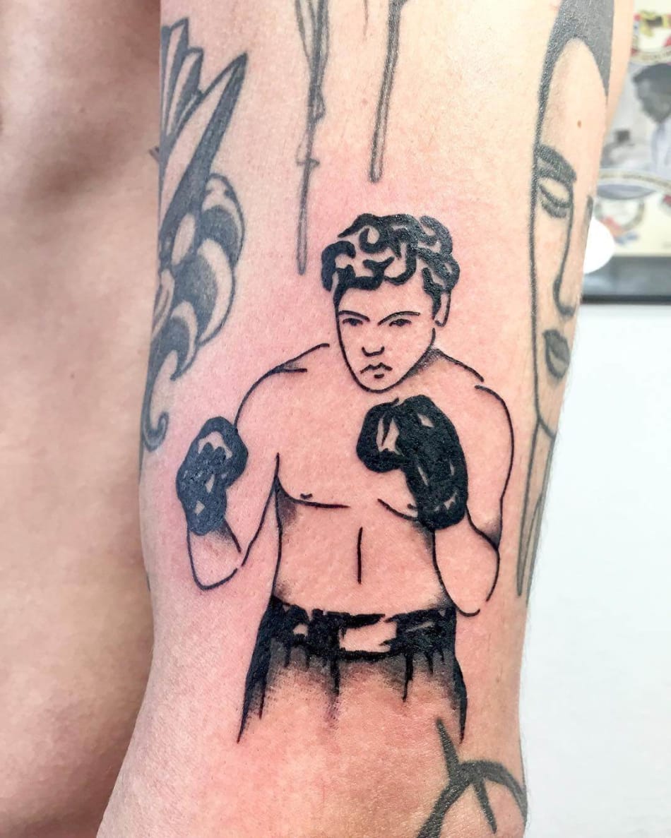 Illustrated boxer tattooed on the arm.