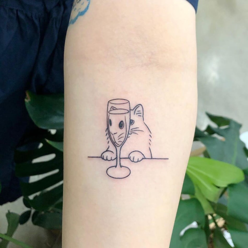 cat looking in champagne glass tattoo by Buoy