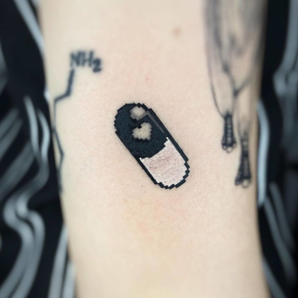 pixel pill tattoo by Fimm tattooer