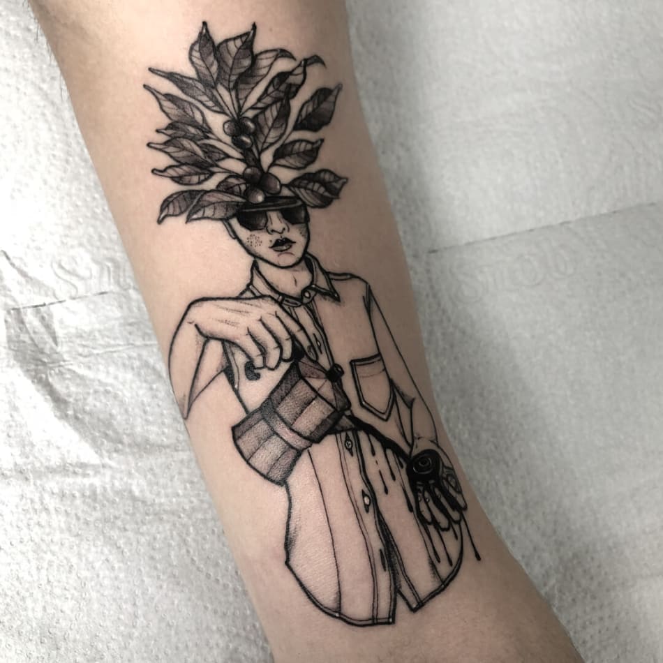 Fine line flower head woman tattoo on the tricep