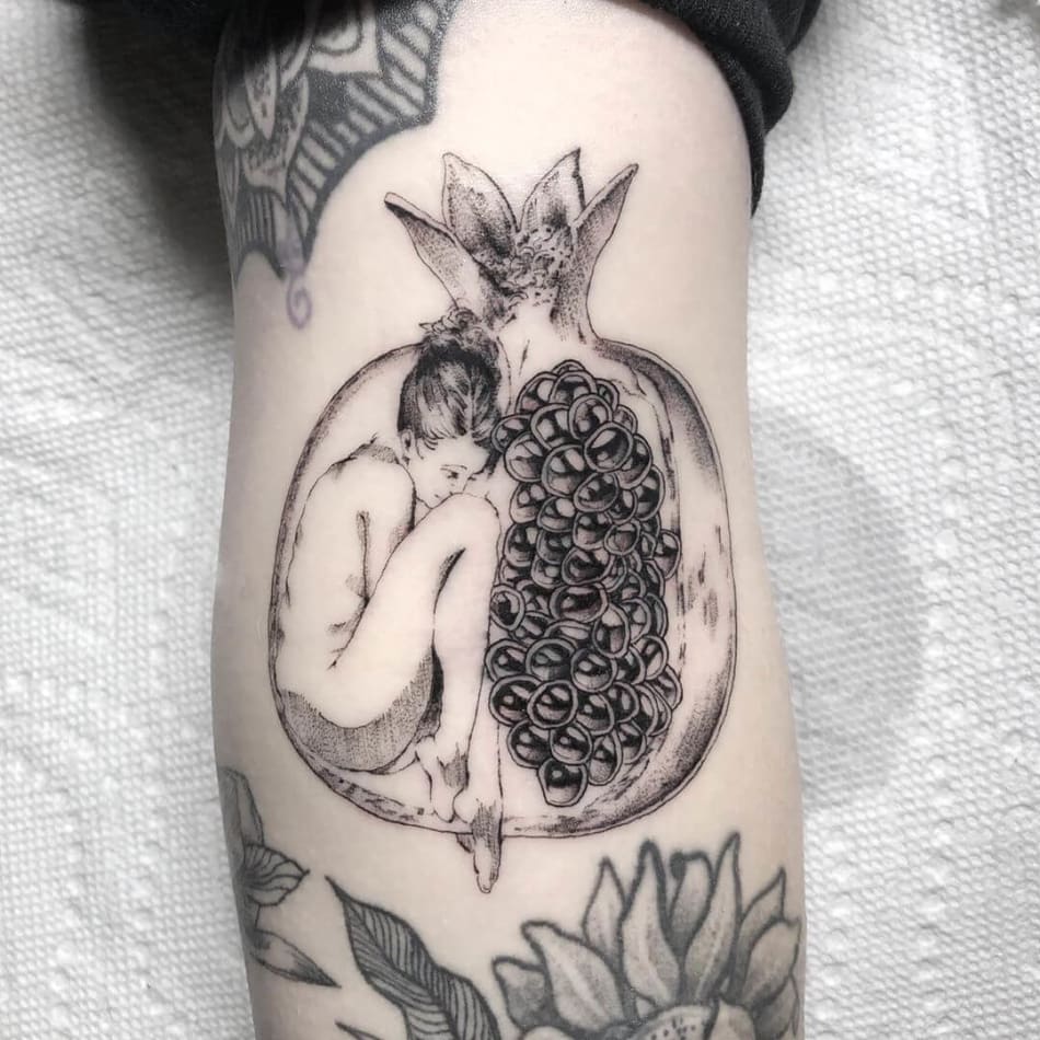 Tattoo of a woman in a pomegranate by Jordy Rios
