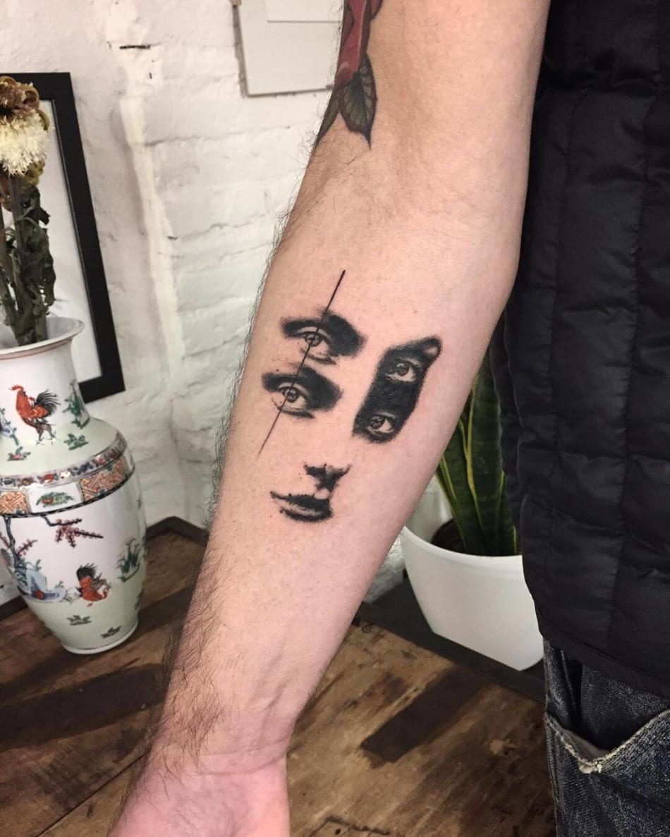 glitched face on arm tattoo by Jerome Wojny