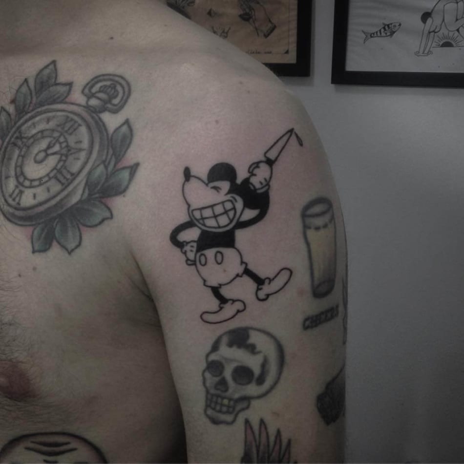 Mickey mouse with a knife tattoo