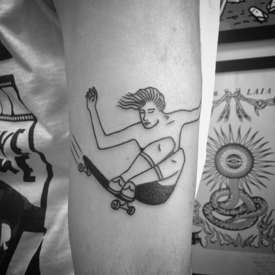 Doing a trick on a skateboard tattoo