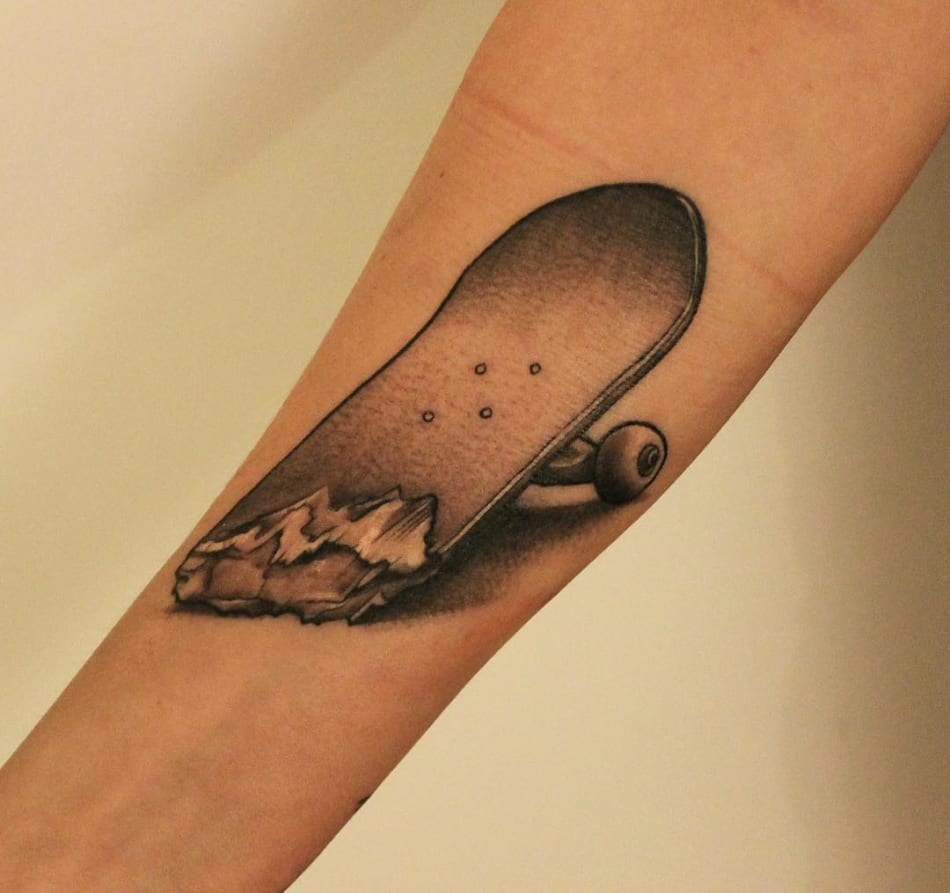 Skateboard in two tattoo