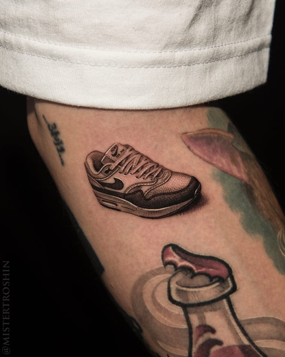 Tattoo of a nike air max shoe on the arm