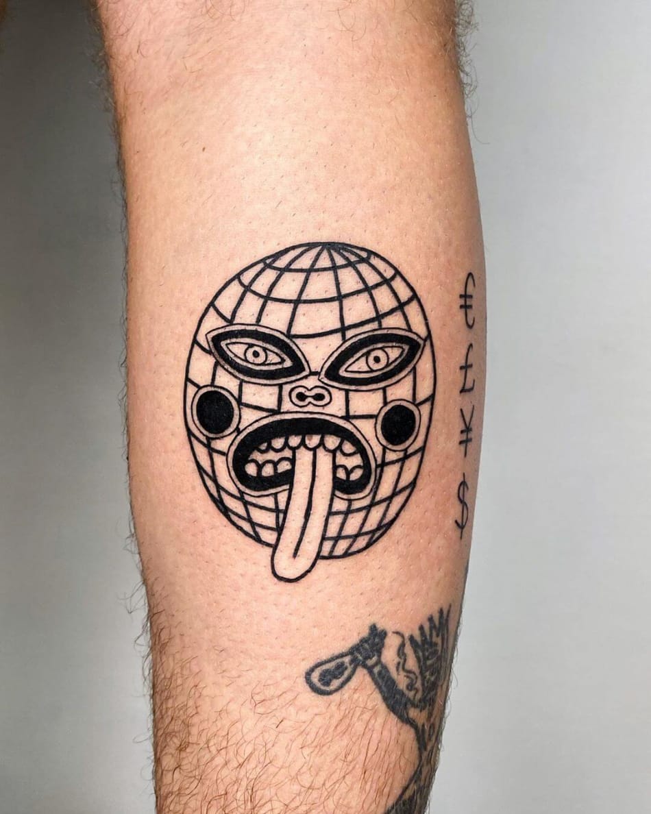 world with mask and tongue out tattoo by Super Roger