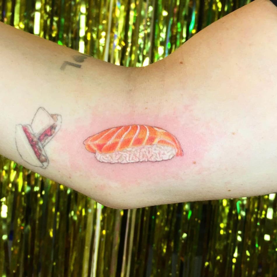 Realistic tattoo of a piece of salmon sushi