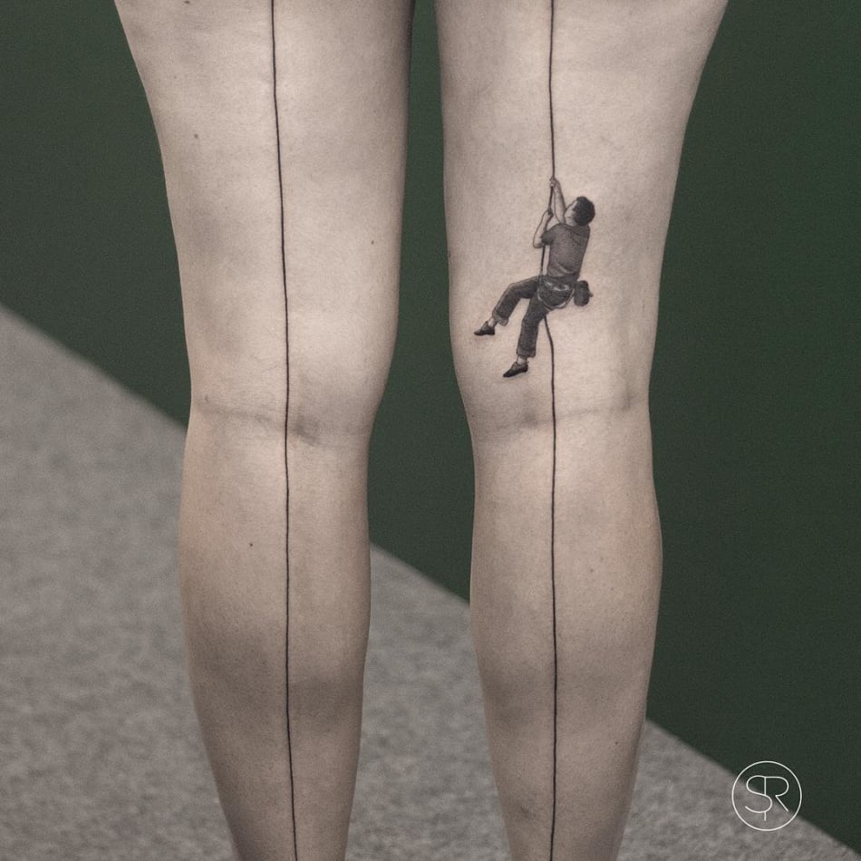 Window washer climbing on leg tattoo by Sven Rayen