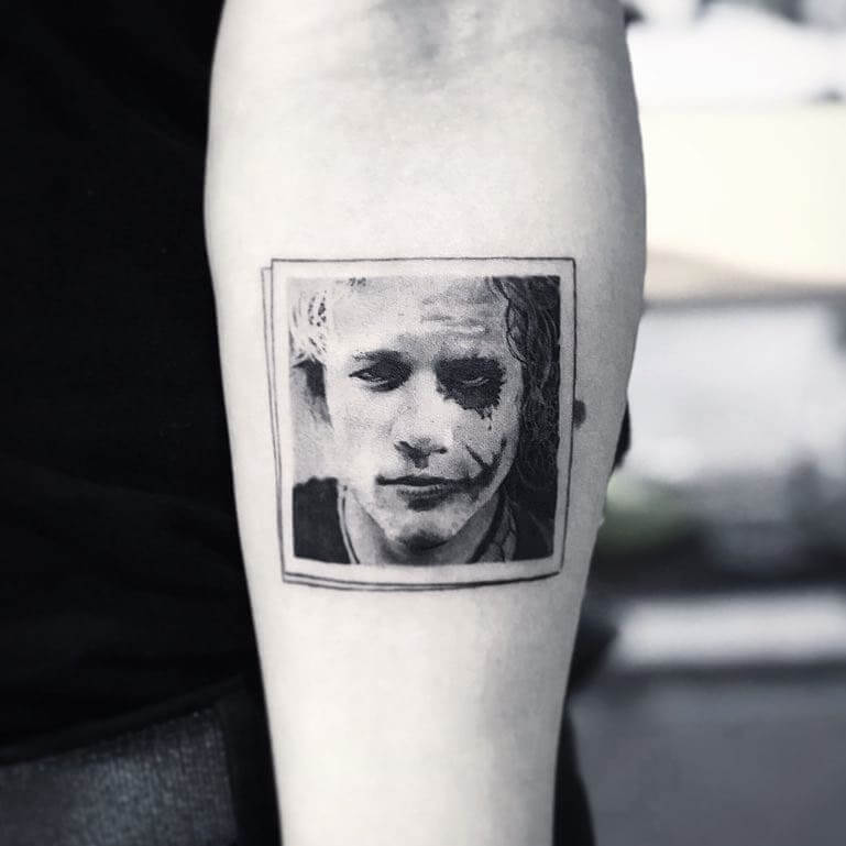 Tattoo portrait of Heath Ledger with half his face as The Joker