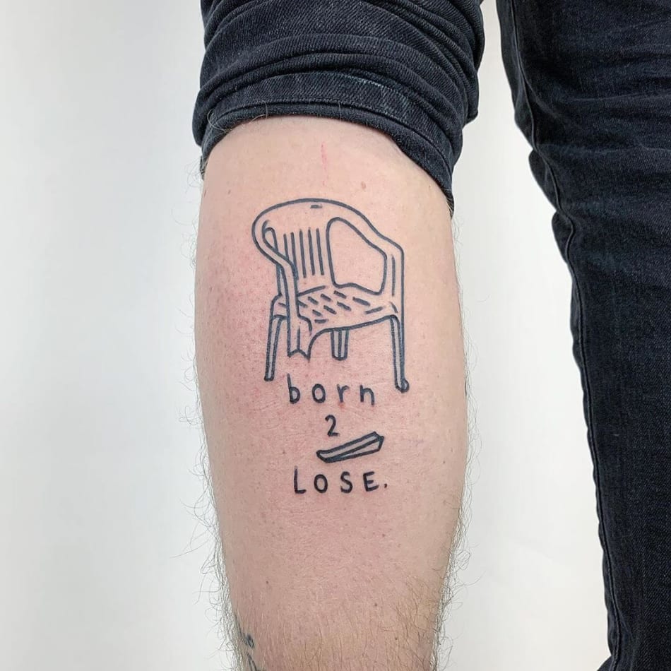 Broken chair tattoo with the text Born to lose, by The Magic Rosa