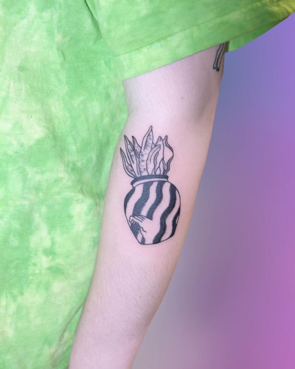 Tattoo of a graphic vase with leaves