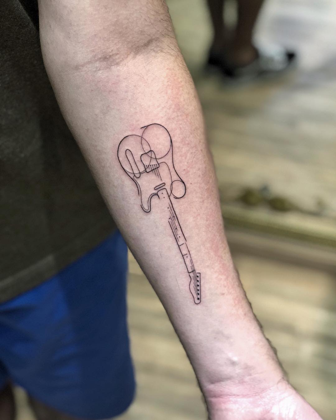 Linework tattoo of an electric guitar