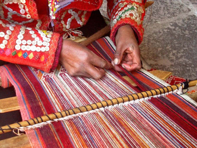 Male weaver creating a handmade fabric